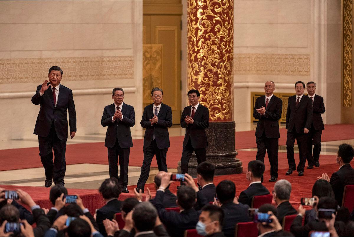 (L–R) Members of the new Standing Committee of the Political Bureau of the Communist Party of China, CCP head Xi Jinping, Li Qiang, Zhao Leji, Wang Huning, Can Qi, Ding Xuexiang, and Li Xi as they arrive for a group photo at a meeting with Chinese and Foreign Journalists at The Great Hall of People in Beijing, on Oct. 23, 2022. (Kevin Frayer/Getty Images)