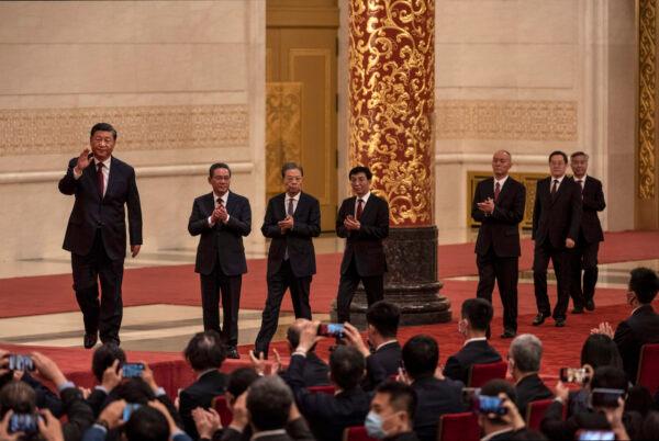 Chinese Communist Party leader Xi Jinping (left) walks with members of the new Standing Committee of the Party’s Political Bureau, (from 2nd left) Li Qiang, Zhao Leji, Wang Huning, Can Qi, Ding Xuexiang, and Li Xi as they arrive for a group photo with journalists at The Great Hall of the People in Beijing, China, on October 23, 2022. (Kevin Frayer/Getty Images)