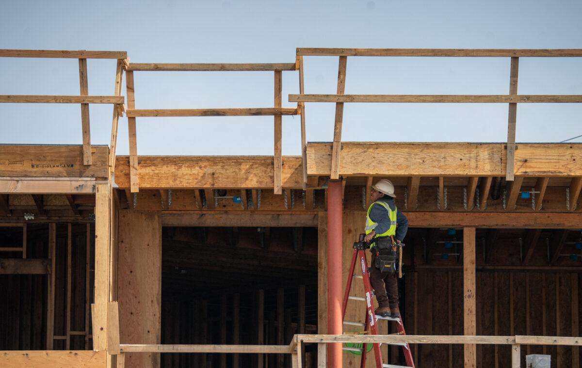 A construction worker builds housing in Huntington Beach, Calif., on March 17, 2023. (John Fredricks/The Epoch Times)