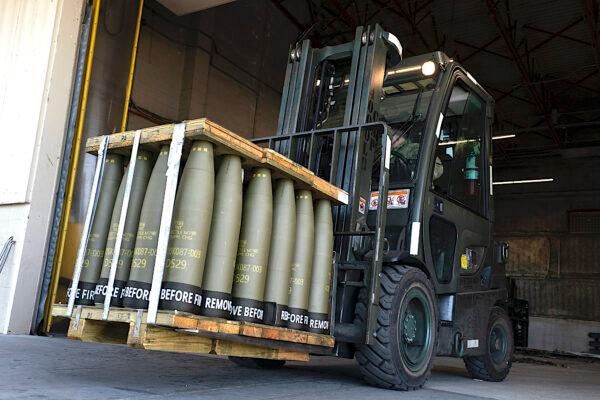 Airmen with the 436th Aerial Port Squadron use a forklift to move 155 mm artillery shells ultimately bound for Ukraine, at Dover Air Force Base in Delaware on April 29, 2022. (Alex Brandon/AP Photo)