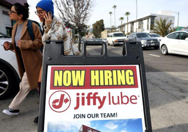 A "Now Hiring" sign is displayed outside a Jiffy Lube location in Los Angeles on Feb. 2, 2023. (Mario Tama/Getty Images)
