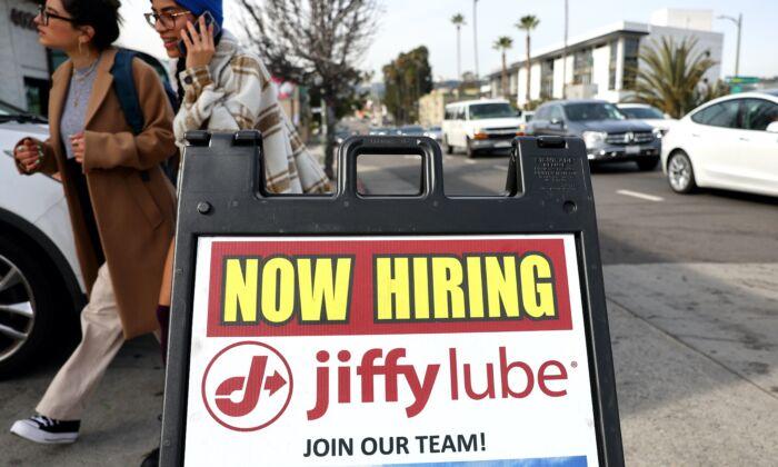 A ‘Now Hiring’ sign is displayed outside a Jiffy Lube location in Los Angeles, Calif., on, on Feb. 2, 2023. (Photo by Mario Tama/Getty Images)