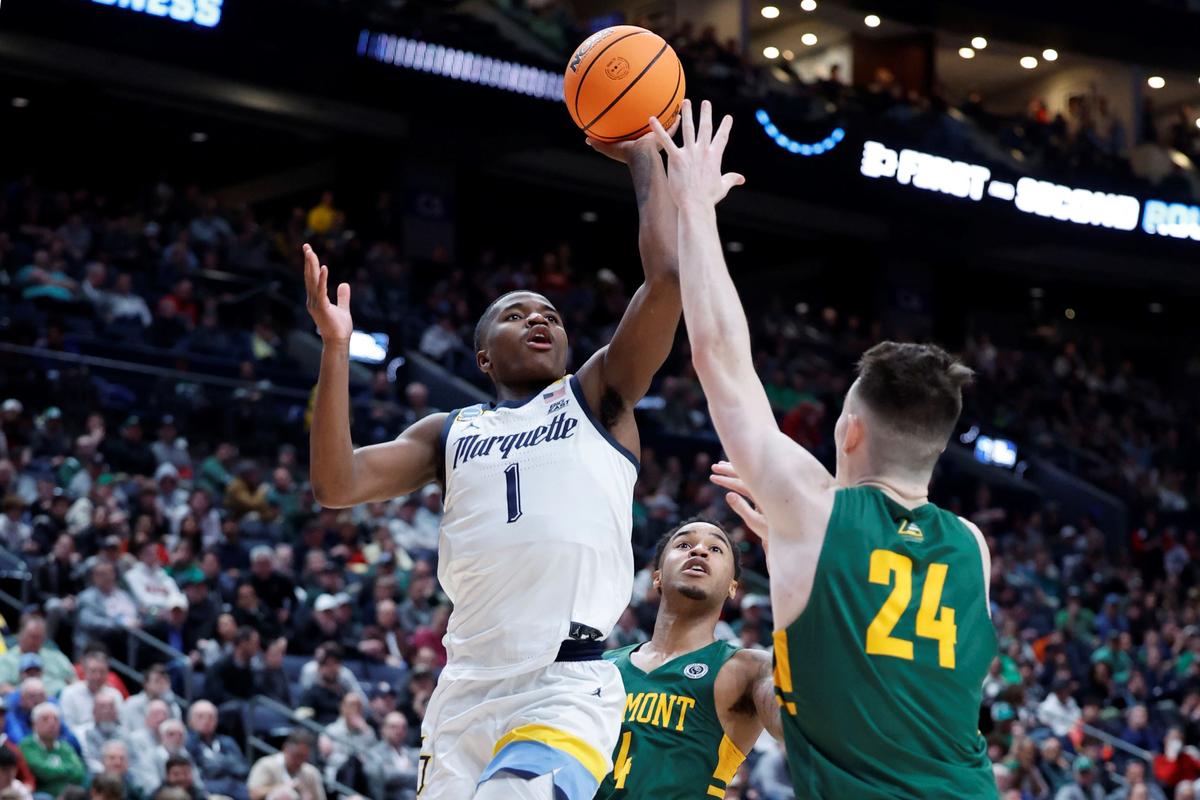 Marquette Golden Eagles guard Kam Jones (1) shoots the ball over Vermont Catamounts forward Matt Veretto (24) in the second half at Nationwide Arena in Columbus, Ohio, on March 17, 2023. (Rick Osentoski/USA TODAY Sports via Reuters)