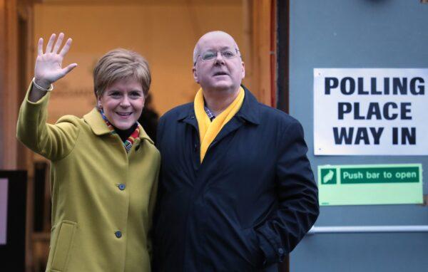 Nicola Sturgeon, then SNP leader and Scottish first minister, and husband Peter Murrell pose after casting their votes in the 2019 General Election at Broomhouse Park Community Hall, Glasgow, Scotland, on Dec. 12, 2019. (Andrew Milligan/PA Media)