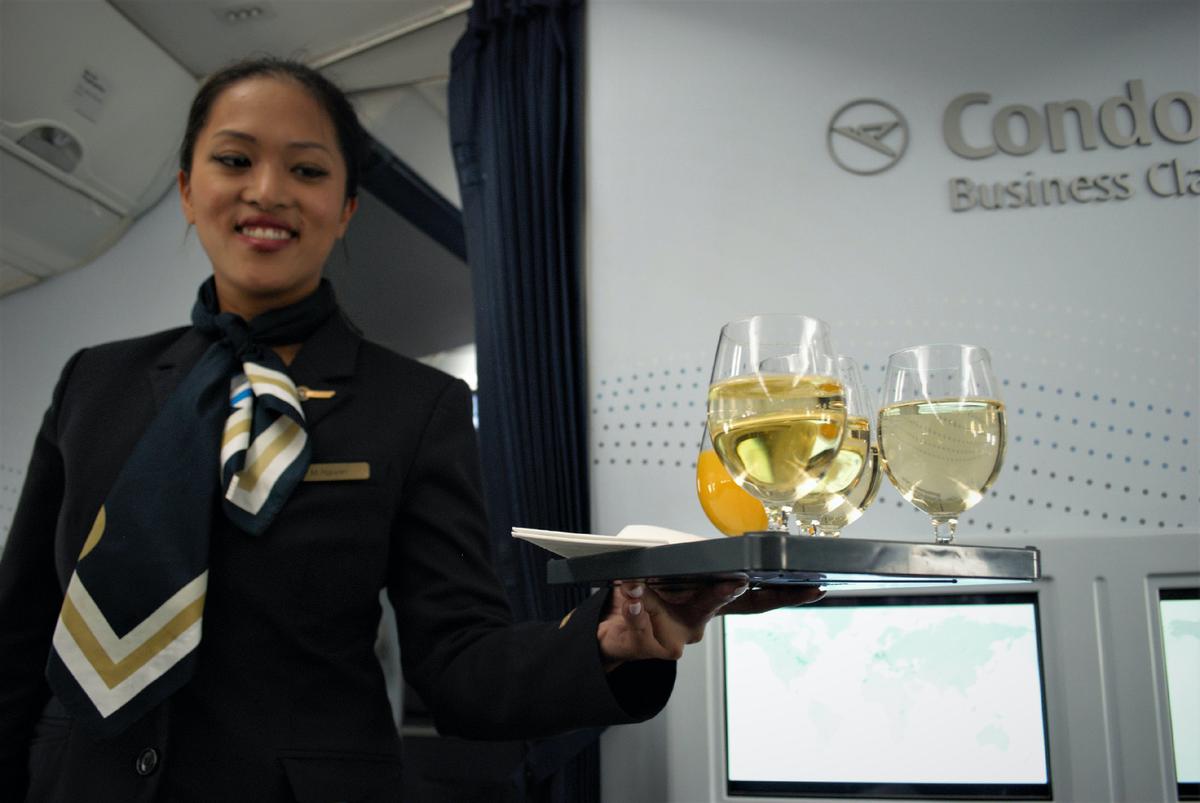 A flight attendant on Condor Airlines offers beverages to passengers en route from Frankfurt, Germany, to Los Angeles. (Photo courtesy of Halina Kubalski)