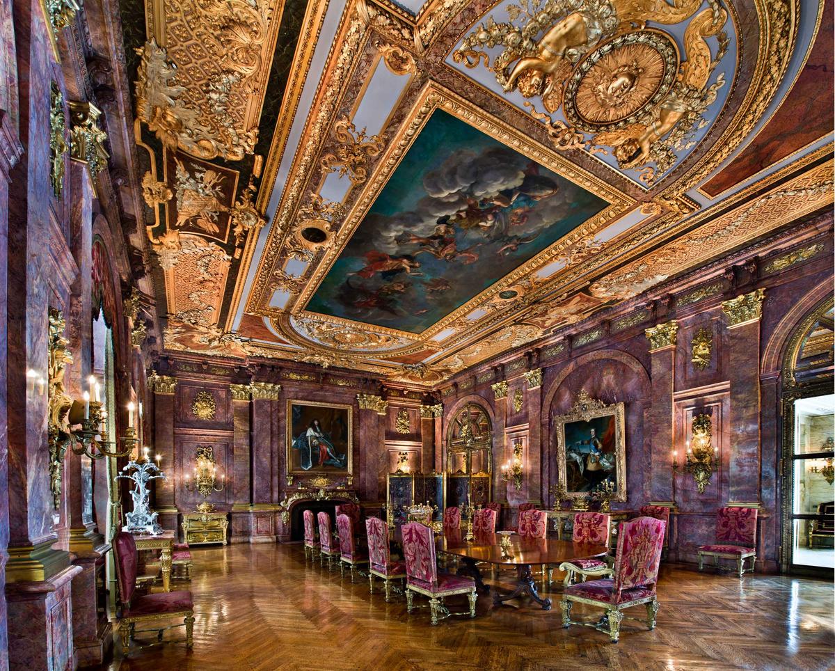 The Dining Room features pink Numidian marble, architectural details of gilded bronze on the walls and ceiling, and furniture of velvet fabric laced with metallic threads. (Courtesy of The Preservation Society of Newport County)
