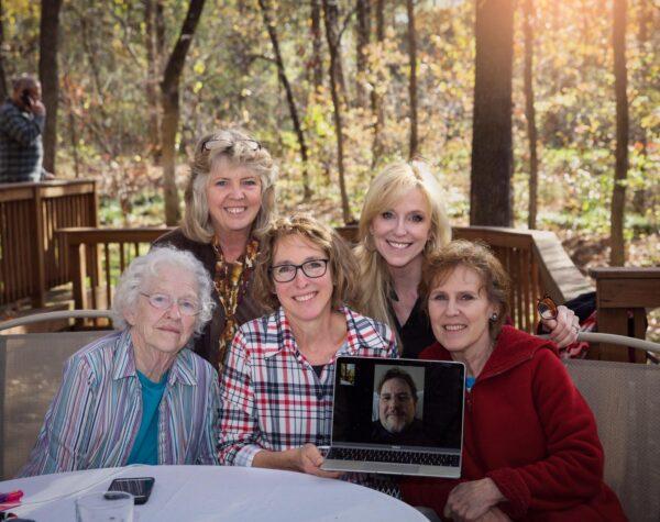 The author (rightmost) with her sisters, brother (on laptop screen), and mother (leftmost). (Courtesy of Judy Walters)
