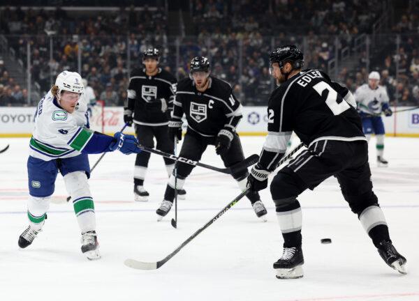 Brock Boeser (6) of the Vancouver Canucks scores on his shot in front of Alexander Edler (2) of the Los Angeles Kings, to take a 1-0 lead, during the first period in Los Angeles on March 18, 2023. (Harry How/Getty Images)