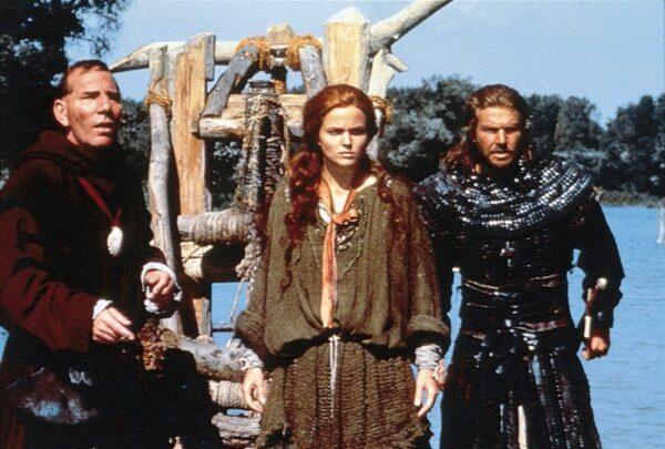 (L–R) Brother Gilbert (Pete Postelwaith), Kara (Dina Meyer) and Sir Bowen) in "Dragonheart." (MovieStillsDB)
