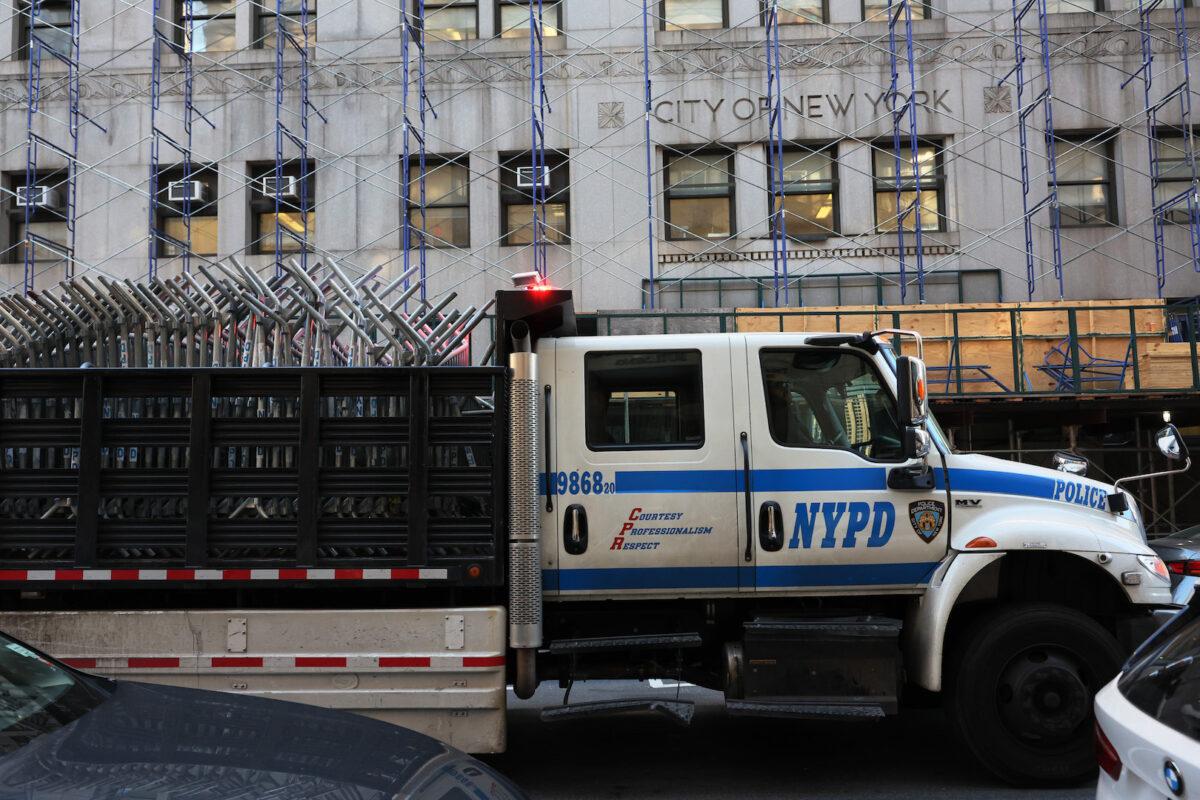An NYPD truck carries metal barricades en route to Manhattan Criminal Court in New York on March 20, 2023. (Michael M. Santiago/Getty Images)