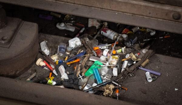 Syringes sit on the train tracks of the Westlake/Macarthur Park train station in Los Angeles, Calif., on March 20, 2023. (John Fredricks/The Epoch Times)