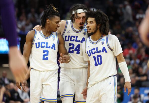 Dylan Andrews (2), Jaime Jaquez Jr. (24), and Tyger Campbell (10) of the UCLA Bruins talk during the second half against the Northwestern Wildcats in the second round of the NCAA Men's Basketball Tournament at Golden 1 Center in Sacramento, Calif., on March 18, 2023. (Ezra Shaw/Getty Images)