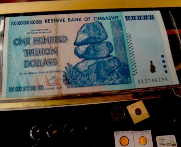 A 100 trillion dollar Zimbabwe note, worth 40 U.S. cents in 2015 because of hyperinflation, was on display at Coin Heaven in Cottonwood, Ariz., on March 20, 2023. (Allan Stein/The Epoch Times)