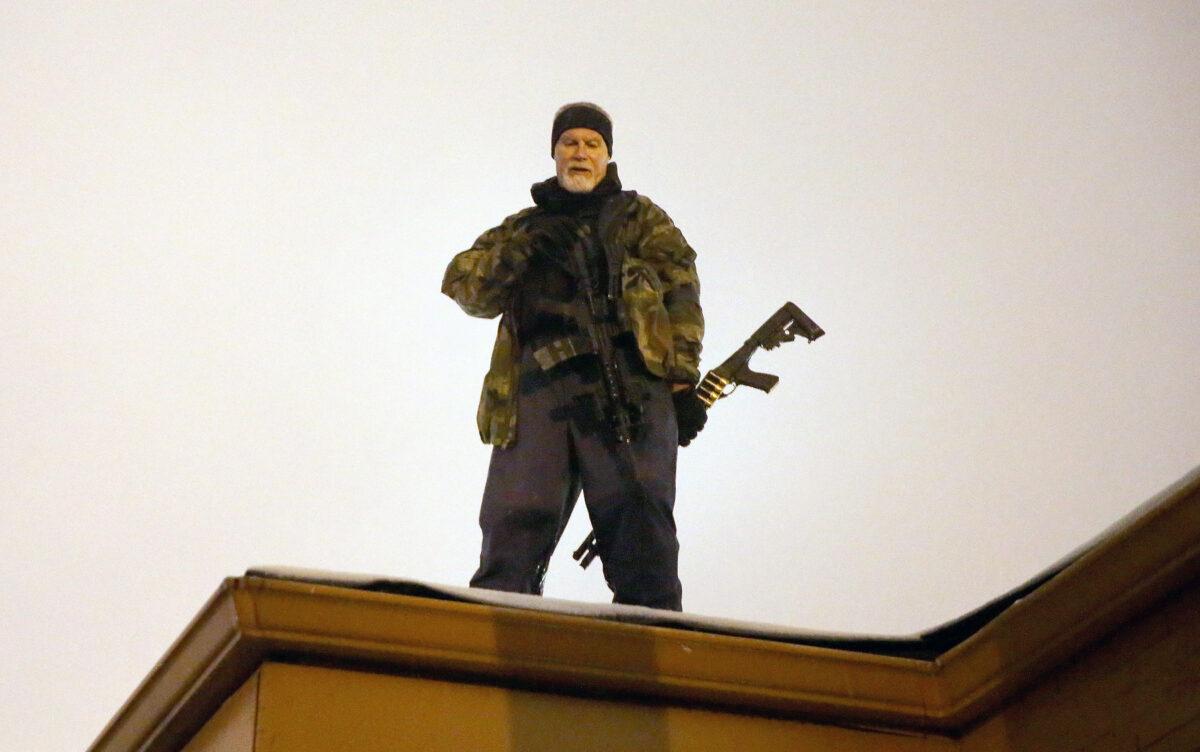 John Karriman, an Oath Keepers volunteer, stands guard on the rooftop of a business on Nov. 26, 2014, in Ferguson, Missouri. (Scott Olson/Getty Images)