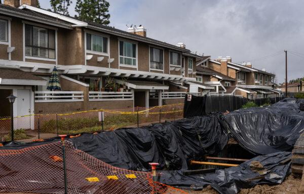 Construction efforts are being made after recent rainstorms opened up a sinkhole in La Habra, Calif., on March 21, 2023. (John Fredricks/The Epoch Times)