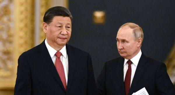 Russian President Vladimir Putin (R) and Chinese leader Xi Jinping enter a hall during a meeting at the Kremlin on March 21, 2023. (Alexey Maishev/Sputnik/AFP via Getty Images)