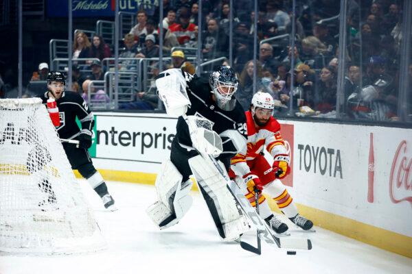 Dillon Dube (29) of the Calgary Flames skates the puck against Pheonix Copley (29) of the Los Angeles Kings in the first period at Crypto.com Arena in Los Angeles on March 20, 2023. (Ronald Martinez/Getty Images)