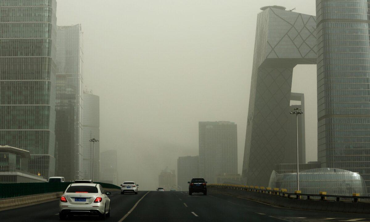 Buildings shrouded in smog amid a sandstorm, at Central Business District (CBD) in Beijing on March 22, 2023. (Tingshu Wang/Reuters)