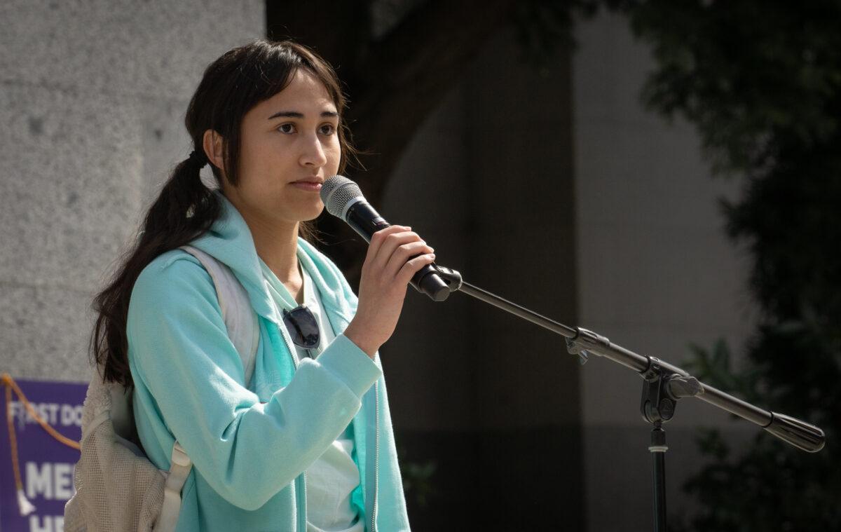 Chloe Cole, who now regrets surgeries she had as a young girl to try to appear more like a boy, shares about detransitioning in front of the California state Capital building in Sacramento on March 10, 2023. (John Fredricks/The Epoch Times)