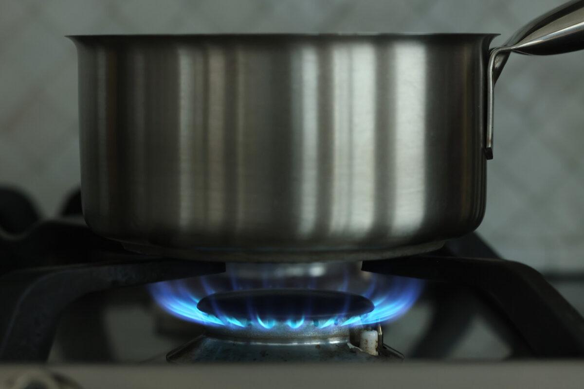 A gas flame burns under a pot on a gas stove top. (Sean Gallup/Getty Images)