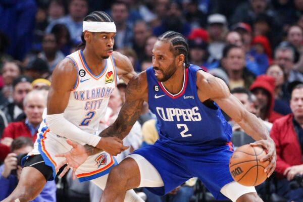 <br/>Los Angeles Clippers forward Kawhi Leonard (R), is defended by Oklahoma City Thunder guard Shai Gilgeous-Alexander during the first half of an NBA basketball game in Los Angeles on March 21, 2023. (Ringo H.W. Chiu/AP Photo)