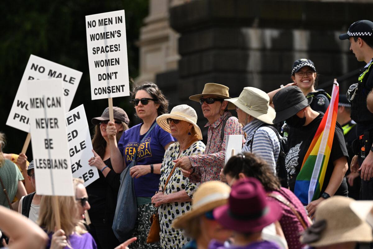 Pro-women protesters (left) and transgender rights protesters (right) gather outside Parliament House in Melbourne on March 18, 2023. (James Ross/AAP Image)