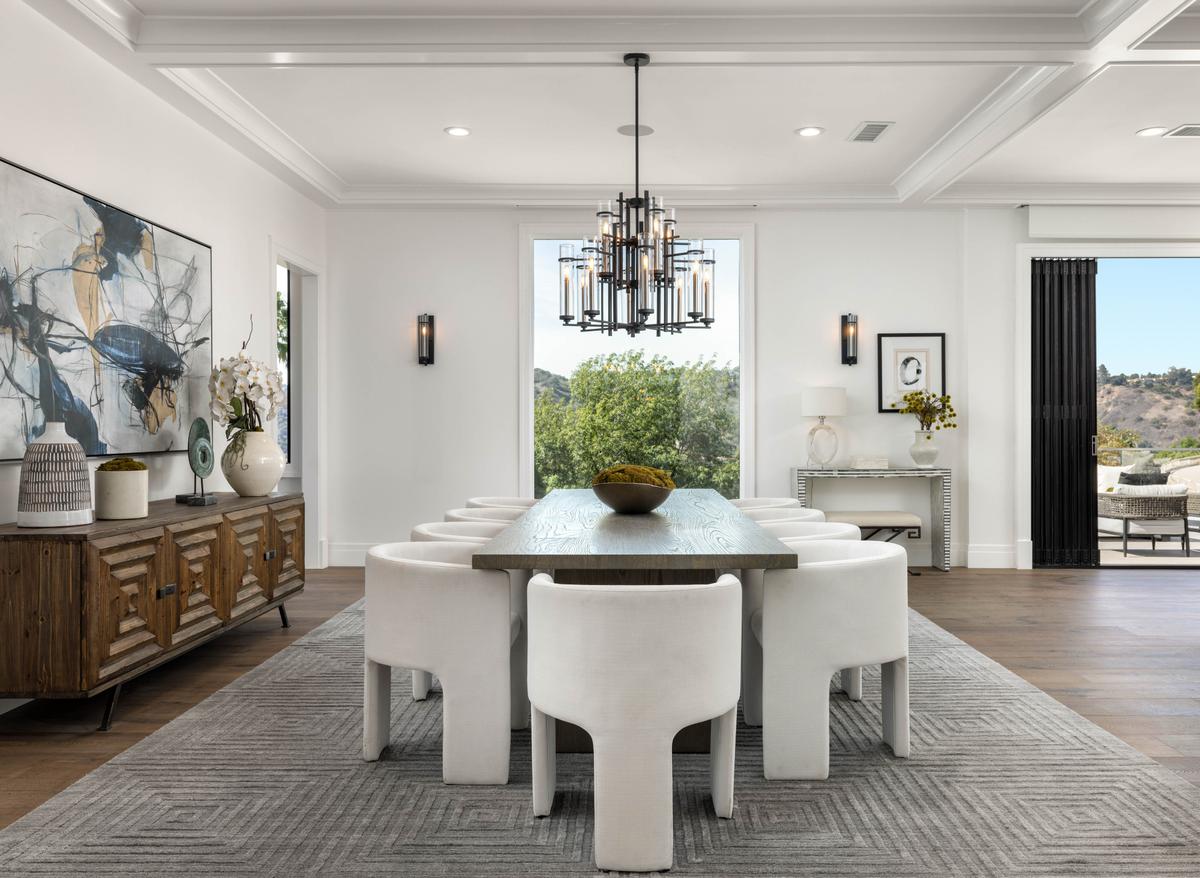 The elegant dining room can accommodate a large family as well as large groups, and is accented by tall ceilings with custom millwork and white oak flooring. (Courtesy of Tyler Hogan and TopTenRealEstateDeals.com)