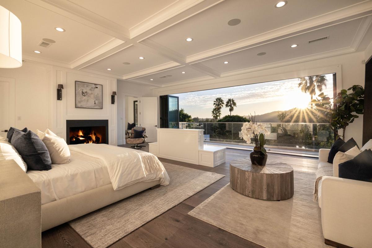 The master bedroom also features a glass wall that opens to provide an unobstructed view, with a fireplace to ward off chilly evenings. (Courtesy of Tyler Hogan and TopTenRealEstateDeals.com)