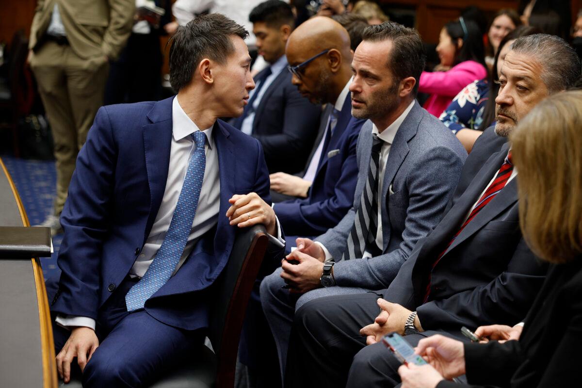 TikTok CEO Shou Zi Chew (L) talks with his company's Vice President for Public Policy Michael Beckerman (C) during a break in Chew's testimony before the House Energy and Commerce Committee in the Rayburn House Office Building on Capitol Hill in Washington, on March 23, 2023. (Chip Somodevilla/Getty Images)