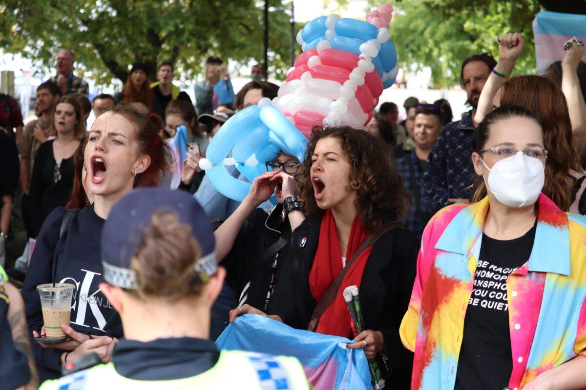 Demonstrators are seen during a protest against an event by British activist Kellie-Jay Keen-Minshull at the Tasmanian Parliament House lawns in Hobart, Australia on March 21, 2023. (AAP Image/Ethan James)