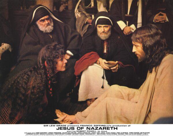Mary Magdalene (Anne Bancroft, L) washes the feet of Jesus (Robert Powell, R) as Joseph of Arimathea (James Mason, C) watches, in "Jesus of Nazareth." (MovieStills DB)