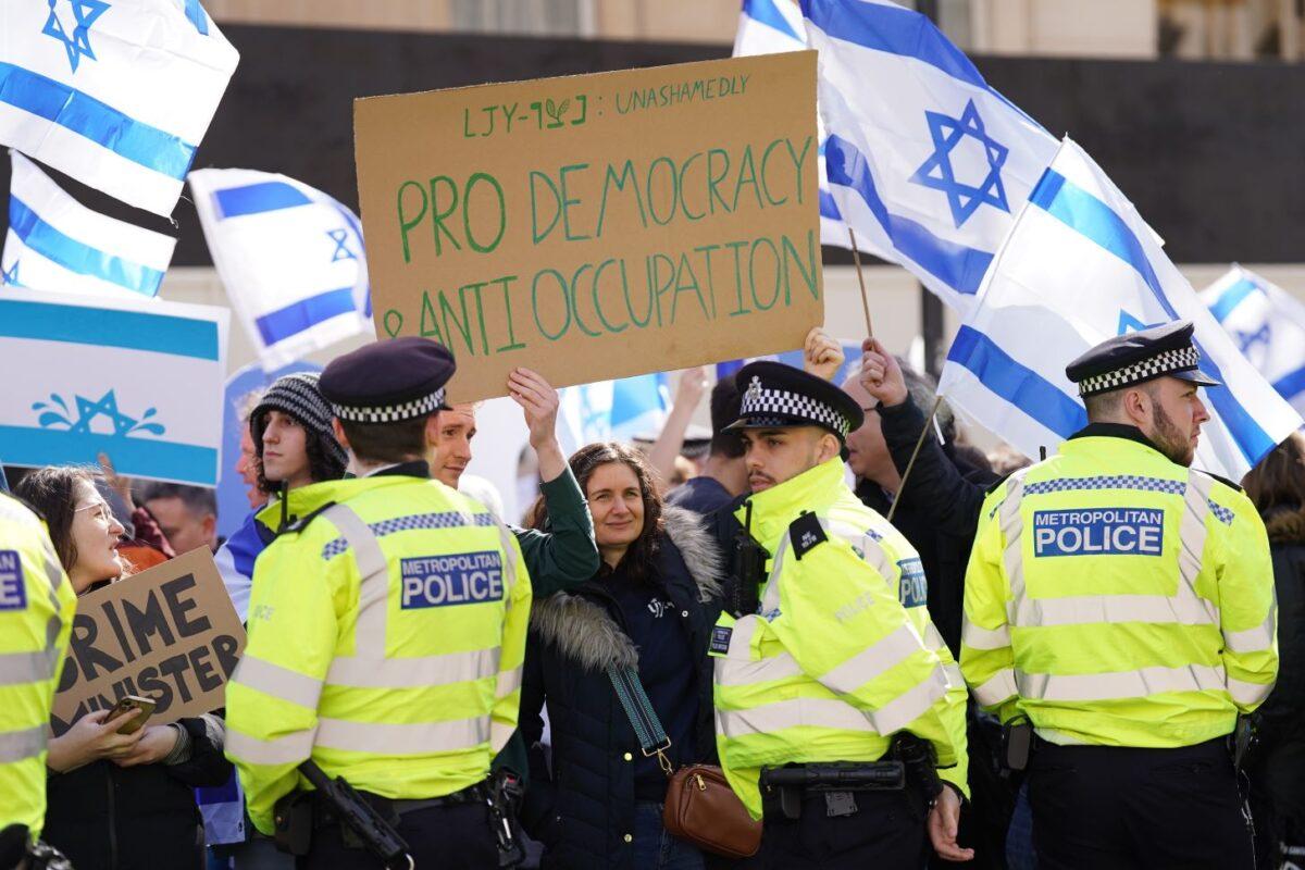 Demonstrators wave Israeli flags during a protest as British Prime Minister Rishi Sunak met with Israel's Prime Minister Benjamin Netanyahu in Downing Street, London, on March 24, 2023. (PA)