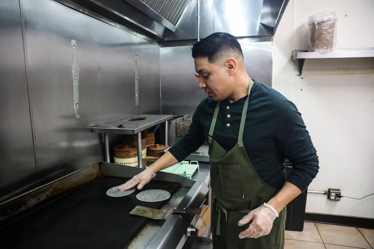 Chef DJ Flores uses freshly made masa to create corn tortillas at Milpa, his Mexican restaurant in the southwest Las Vegas valley, Thursday, March 9, 2023. The restaurant is one of the few in Las Vegas that makes corn tortillas from scratch using the traditional nixtamalization process. (Rachel Aston/Las Vegas Review-Journal/TNS)