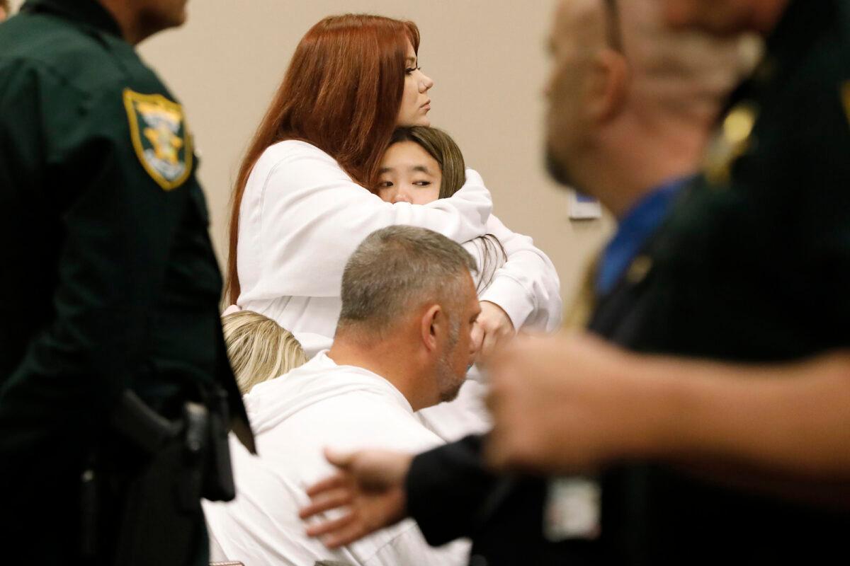 Alexis Bailey, one of the sisters of Tristyn Bailey, gets a hug from one of Tristyn's friends after the verdict was handed down during the sentencing hearing for Aiden Fucci, in St. Augustine, Fla., on March 24, 2023. (Bob Self/The Florida Times-Union via AP)