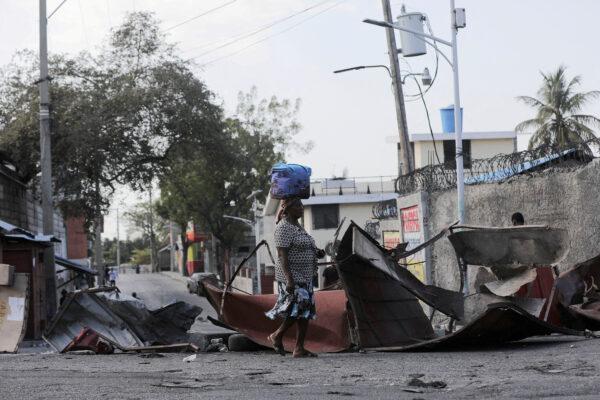 A woman walks past a barricade amid gang violence in Port-au-Prince, Haiti, on March 3, 2023. (Ralph Tedy Erol/Reuters)