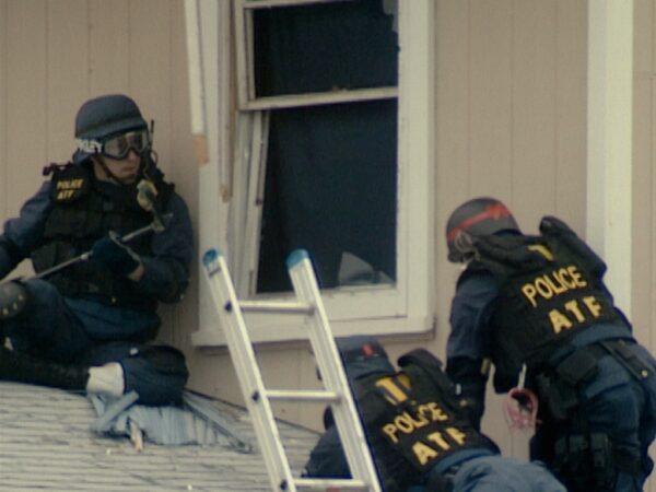 Law enforcement storming the Branch Davidian compound in "Waco: American Apocalypse." (Netflix)
