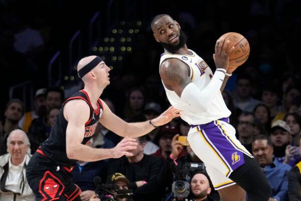 Los Angeles Lakers forward LeBron James, right, is defended by Chicago Bulls guard Alex Caruso during the first half of an NBA basketball game, in Los Angeles on March 26, 2023. (Marcio Jose Sanchez/AP Photo)