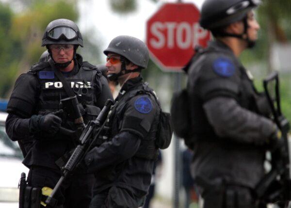 Miami SWAT team members stand in front of a home that was raided in Miami on Sept. 27, 2006. (Joe Raedle/Getty Images)