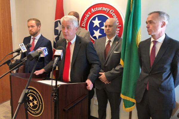 Shelby County District Attorney Steve Mulroy, at lectern, speaks with reporters during a news conference in Memphis, Tenn., on March 27, 2023, announcing that his office will seek the death penalty if Ezekiel Kelly is convicted of first-degree murder in a daylong shooting rampage that left three people dead and three others wounded. (Adrian Sainz/AP Photo)