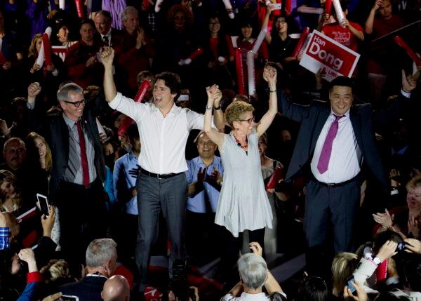 Han Dong (R), then a provincial Liberal candidate, on the stage with Justin Trudeau (2nd L) and then-Ontario Premier Kathleen Wynne (3rd L) in Toronto on May 22, 2014. (Nathan Denette/The Canadian Press)