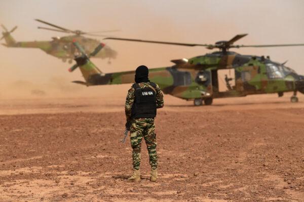 A soldier of the French Special and Intervention Unit of the National Gendarmerie stands next to an NH90 Caiman Helicopter on July 15, 2022, as part of an official visit of French Ministers of Foreign Affairs and Armed Forces to Niger. (Bertrand Guay/AFP via Getty Images)