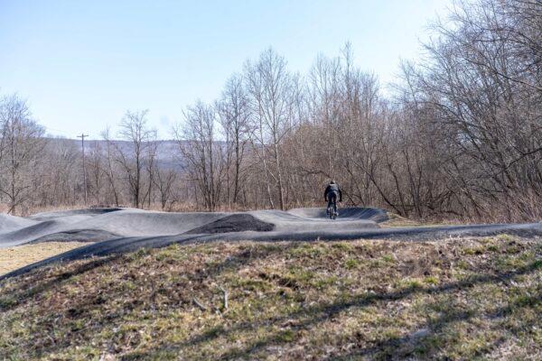 A biker rides on the pump track in Port Jervis, N.Y., on March 16, 2023. (Cara Ding/The Epoch Times)