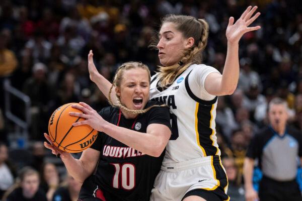 Louisville guard Hailey Van Lith (10) drives past Iowa guard Kate Martin during the first half of an Elite 8 college basketball game of the NCAA Tournament in Seattle on March 26, 2023. (Stephen Brashear/AP Photo)
