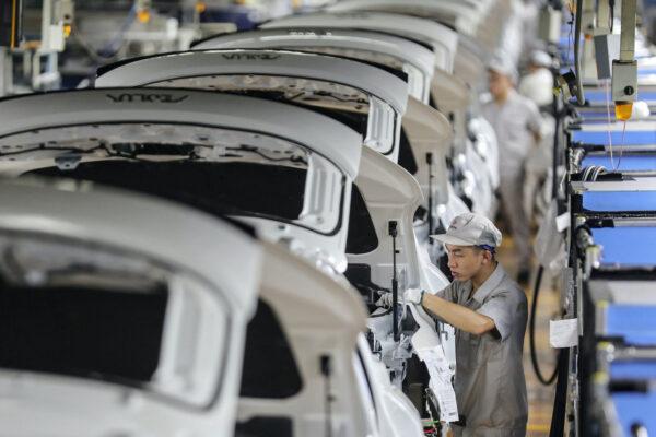 An employee working on a car assembly line at a Dongfeng factory in Wuhan in China's central Hubei Province on Sept. 14, 2020. (STR/AFP via Getty Images)