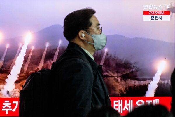 A man walks past a television showing a news broadcast with file footage of a North Korean missile test at a railway station in Seoul on March 27, 2023. North Korea fired two short-range ballistic missiles on March 27, South Korea's military said, the latest in its flurry of weapons tests in recent weeks. (Anthony Wallace/AFP via Getty Images)