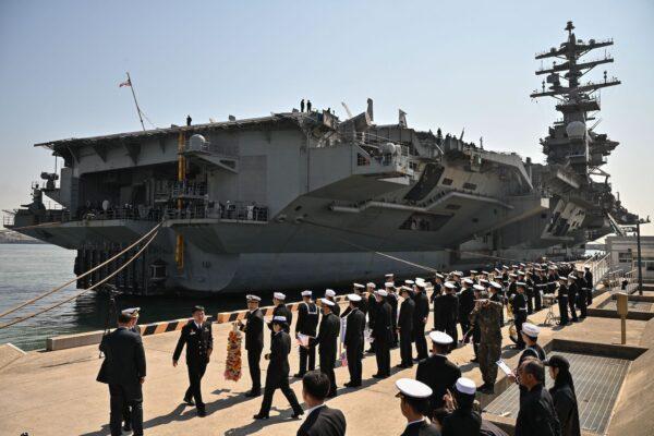 South Korean Navy personnel are seen standing alongside the USS Nimitz, during its port visit to Busan on March 28, 2023. (Anthony Wallace/AFP via Getty Images)