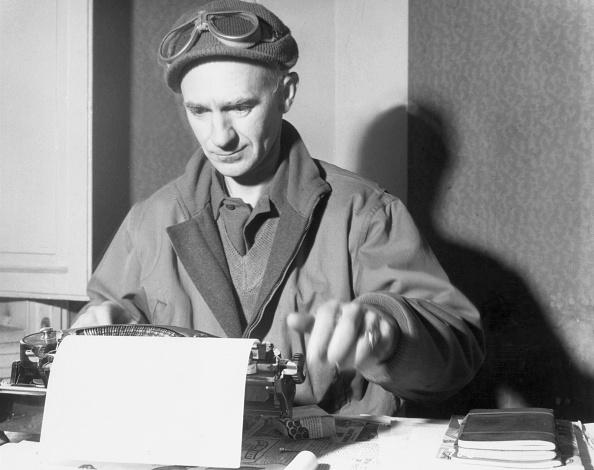 American journalist Ernie Pyle, circa 1945, types at a desk in a jacket, a knit cap, and goggles. (Hulton Archive/Getty Images)