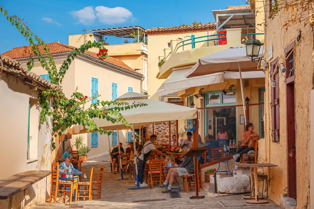 Shop for souvenirs, visit high-end galleries, and sample Greek foods and wine in the neighborhood of Plaka, Athens. (Adisa/Shutterstock)