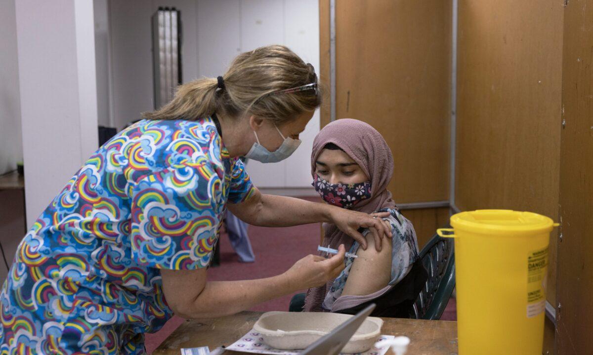 Members of the public have the AstraZeneca COVID-19 vaccination at Fazl Mosque in Southfields as they host a drop in clinic, in London, on June 8, 2021. (Dan Kitwood/Getty Images)