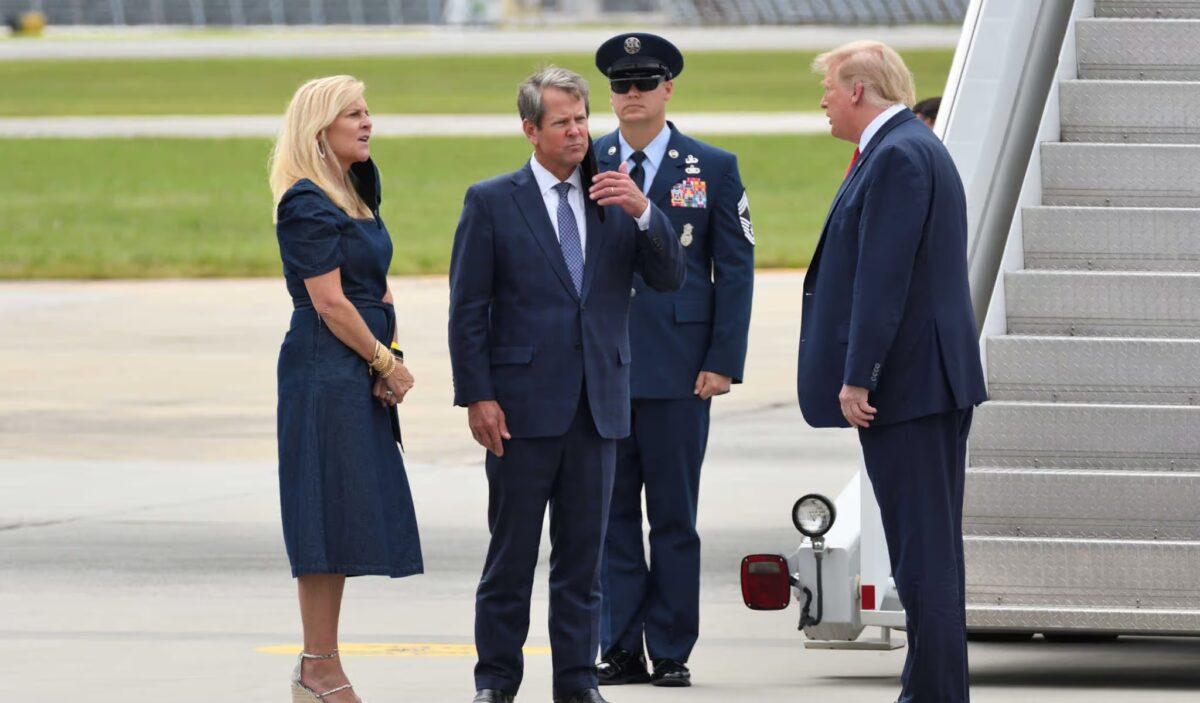 Then-President Donald Trump greets Georgia Gov. Brian Kemp, a Republican, and Georgia First Lady Marty Kemp upon exiting Air Force One at Dobbins Air Reserve Base in Marietta, Ga., on Sept. 25, 2020. (Evan El-Amin/Shutterstock)